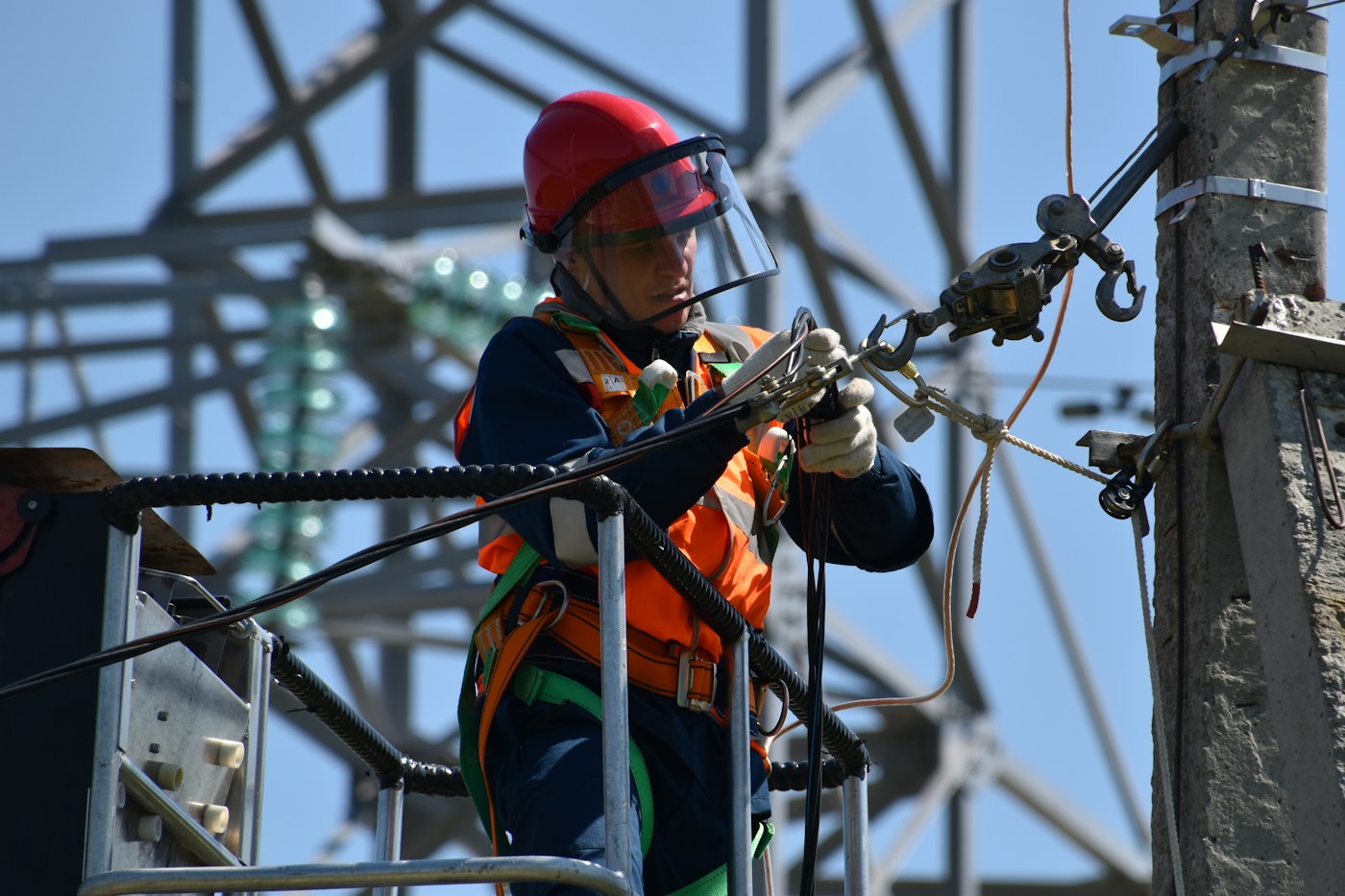 Electrical line technician working with safety equipment